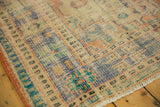 Worn knot heads and faded blue, peach, mint patterns on a distressed Oushak carpet.