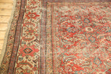Vintage Mahal carpet corner with oversized Herati motif, cherry red, ivory, and mostly even wear.