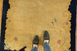 Hand-knotted vintage Peking rug with pale gold open field, Rococo border, and bird motif.