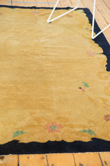 Vintage Peking rug's gold field featuring a colorful bird and blush mauve, mint green floral motifs.