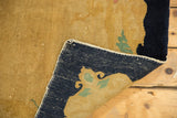 Hand-knotted vintage Peking rug's back, revealing navy foundation, original selvage, and golden pile.