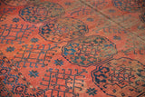 Vintage Ersari rug showcasing oversized gul motifs and geometric hooked patterns in cochineal red and blues.