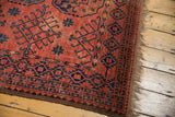 Vintage Ersari square carpet corner, cochineal red, geometric navy border, and original selvage.