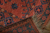 Ersari vintage carpet detail: cochineal red pile, original plain weave back, and fringe.