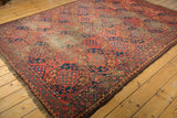 Antique Ersari carpet's cochineal red field with triple gul and diamond motifs, original selvage visible.