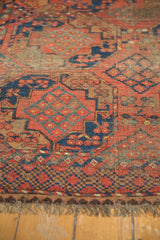 Antique Ersari rug's geometric border with red, blue, brown motifs and secured fringe.