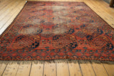 Antique Ersari carpet corner: cochineal red, blue gul motifs, original selvage, and fringe.