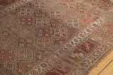 Worn intricate checkered floral motifs showing knot heads on an antique Kurdish runner.