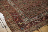 Antique Kurdish runner corner showing tattered side, playful main border, and intricate field motif.