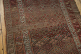 Antique Kurdish runner detail showing intricate lattice floral pattern, varied border, and visible foundation wear.