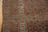 Antique Kurdish runner: intricate checkered floral lattice, border's varied tones, and worn edge.