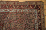 Antique Kurdish runner corner detail, checkered floral motif, playful variegated borders, tattered edge.