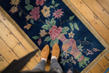Art Deco rug with intricate floral vase design and playful color fills.