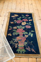 Lower right view of vintage Chinese Art Deco rug with ornate vase, green, blush motifs.