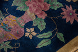 Intricate mint green leaves and dusty blush florals on dark cobalt blue Art Deco rug.