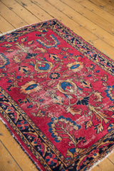 Visible foundation and detailed floral palmettes on a cherry red vintage Lilihan rug.