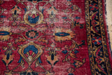 Cherry red vintage Lilihan rug, gold palmettes, blue motifs, low pile, patterned border.
