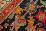 Vintage Malayer runner pile texture with intricate henna plant motif in navy, tangerine, and ivory.
