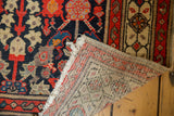 Hand-knotted foundation and tattered fringe of a vintage Malayer runner, showing navy henna motif.