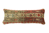 Antique rug fragment lumbar pillow, red, beige, and black geometric bands with floral motifs. 9x23.