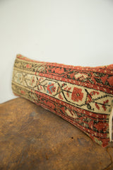 Hand-knotted pile of the antique rug fragment pillow featuring intricate red and cream motifs.