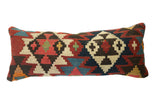 Antique Kilim Lumbar Pillow showcasing tribal geometric patterns in terracotta, indigo, and cream.