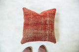 Varied red hues and textured weave on an antique Turkish rug fragment pillow.