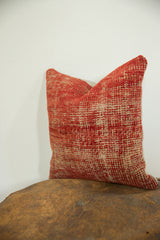 Fine texture and nuanced red and beige tones on the hand-knotted antique Turkish pillow.