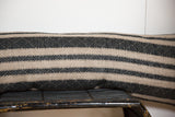 Pillow fabric with contrasting natural bands and onyx black textured geometric stripes.