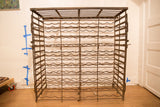 Upper detail of antique French iron wine rack with wavy supports and patina.