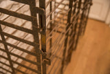 Aged iron framework detail of the antique French wine rack, showcasing rustic patina.