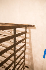 Antique French iron wine rack detail showing its rustic, aged texture.