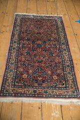 Hand knotted Kerman rug showing delicate blue floral vinery on dusty red and ivory.