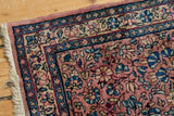 Vintage Kerman runner with dusty mauve field, blue floral cross-sections, and ivory tendrils.