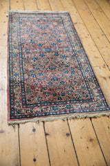 Vintage Persian Kerman runner end with light fringe and delicate floral pattern corner.