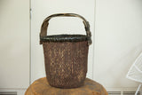 Dark woven texture, black wrapped rim, and curved handle of the Chinese Willow basket.