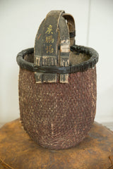 Textured brown weaving and black binding of a vintage Chinese willow basket.
