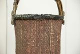 Willow basket with dark wrapped rim and reddish-brown woven texture.