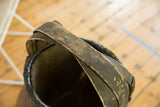 Worn black handle with yellow script detail on Chinese willow basket.