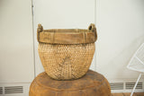 Close-up of the natural woven texture and wooden rim of the vintage willow basket.