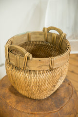 Natural willow basket's detailed weave, sturdy wooden rim, and integrated handles.
