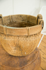 Tight circular weave on the bottom of the natural vintage willow basket.