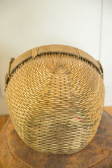 Vintage willow basket's woven base, showcasing its natural tone and concentric circular weave.