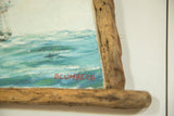 Red Blumberg signature and wormwood frame detail on the seascape painting.