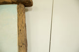 Textured wormwood frame detail with the painting's light blue edge.