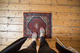 Vintage Persian Mir Sarouk rug with central medallion and cranberry, indigo pawn motif borders.