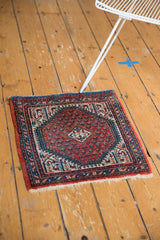 Thick pile of a vintage Mir Sarouk rug, featuring cranberry red, indigo, and ivory patterns.