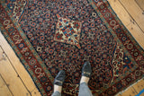 Vintage Hamadan rug detail with navy Herati motif, diamond medallion, and knot wear.