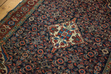 Vintage Persian Hamadan rug detail: Herati motif on navy field, cherry red border.