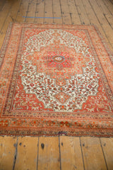 Vintage Farahan Sarouk rug corner with red, ivory floral border and overcast end.
